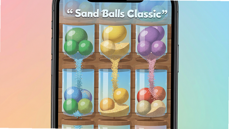 ����Ϊ�ֻ���Ļ��д����Ļ����ʾ Sand Balls Classic ��Ϸ���棬�����ɫɳ�������������У�ɳ����������������Ϊ��͵Ĵ�ɫ���䣬���־��У��Ű��࣬����ִ���ƽ����ϸ��չʾɳ���Ŀ����ʸУ����ʸ��壬�ɾ����޶���Ԫ�أ����ּ�����