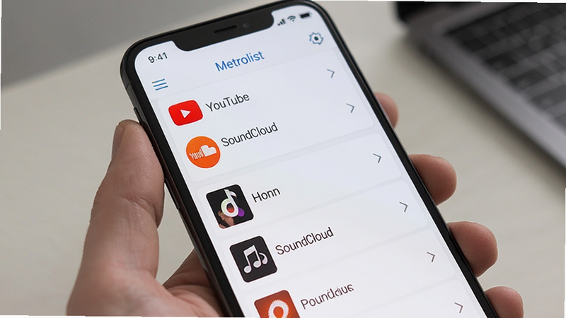 Metrolist app showing multiple music sources in a unified list, icons for YouTube and SoundCloud visible, clean list view, modern smartphone screen