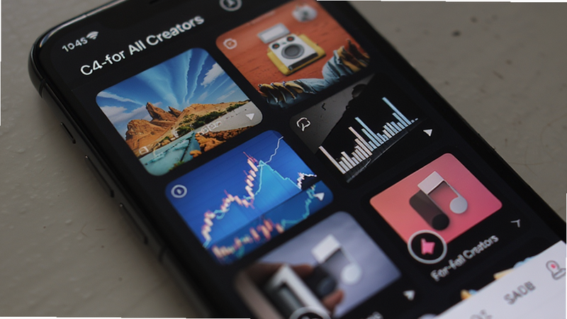 Close-up of a smartphone screen showing a grid of colorful stock photos and music tracks within the C4-for All Creators app, sleek UI design, soft lighting, professional photography style