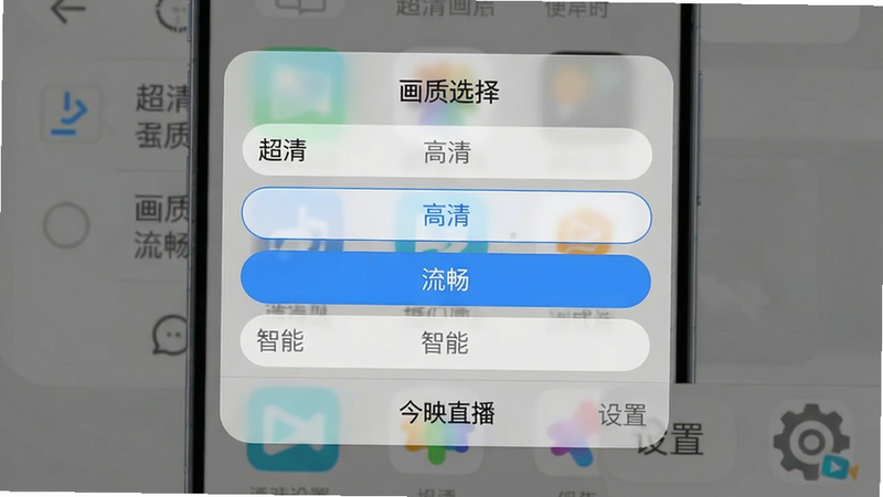 主体:手机设置界面中的画质选择菜单;布局:居中截图,显示“画质选择”弹窗,选项包含“超清”“高清”“流畅”“智能”;排版:弹窗半透明背景,选项为圆角列表,选中项高亮;风格:系统原生风格,简洁直观;细节:弹窗底部有“今映直播”字样,以及“设置”图标;画质:清晰,无多余元素