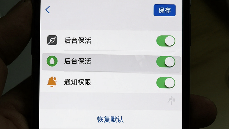 主体:手机屏幕显示轻便签的设置页面,高亮显示“后台保活”和“通知权限”两个选项。布局:设置列表纵向排列,每个选项左侧有图标,右侧有开关。风格:系统设置风格,白底黑字。细节:右上角有“保存”按钮,底部有“恢复默认”链接。画质:清晰,无多余元素。