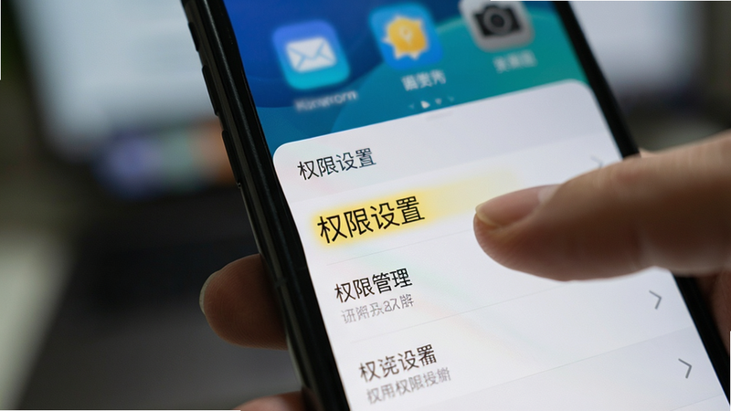一部手机正在显示应用设置界面,手指正在点击“权限管理”选项,背景模糊,焦点清晰,风格写实,细节清晰,文字“权限设置”高亮显示,画质4k,无多余元素