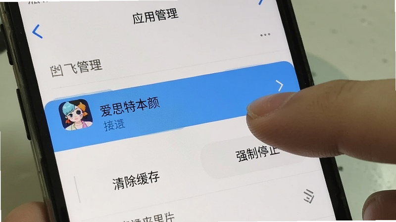 手机设置界面截图,显示“应用管理”列表,其中“爱思特本颜”被高亮选中,下方有“清除缓存”和“强制停止”按钮,手指正准备点击清除缓存,界面清晰,操作指引明确,真实手机拍摄风格