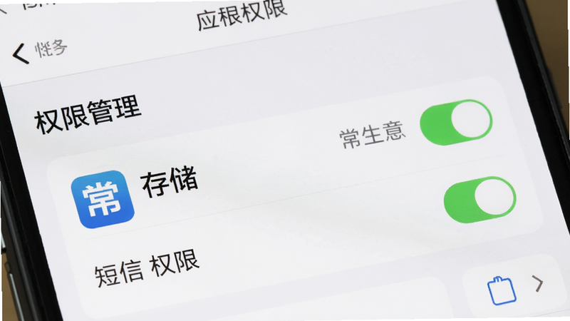 主体为手机设置界面,显示应用权限管理页面,突出常银生意应用的存储和短信权限开启状态,布局简洁,风格系统原生,细节体现开关按钮,高清,干净,无多余元素,文字包含
