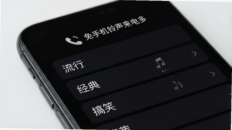 手机屏幕特写,显示“免费手机铃声来电多”APP界面,深色模式背景,列表式布局展示多个铃声类别,如“流行”、“经典”、“搞笑”,界面简洁现代,高清,无水印,无多余UI元素