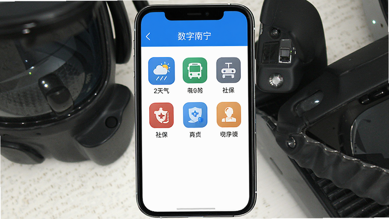 手机屏幕居中显示“数字南宁”APP主界面,顶部为蓝色导航栏,中间展示天气、公交、社保等核心功能图标网格,底部为白色背景,整体风格扁平化、简洁、高清,无多余装饰元素,界面布局整齐规整,色彩以科技蓝和白色为主,画质清晰,无水印,无多余文字